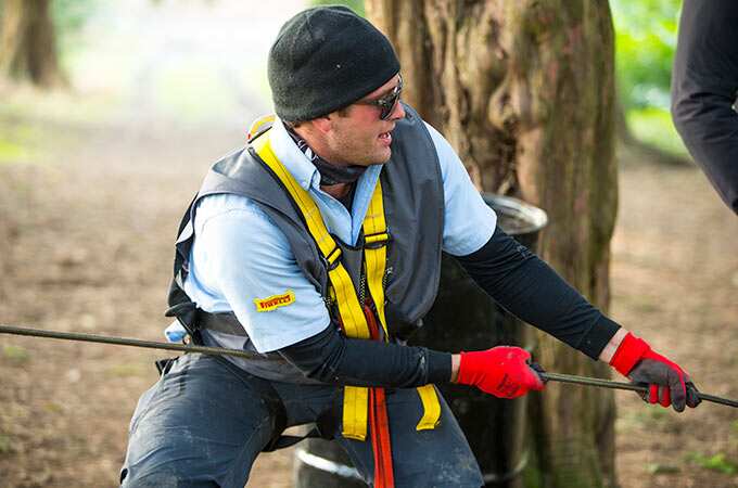 Man pulling on winch rope 